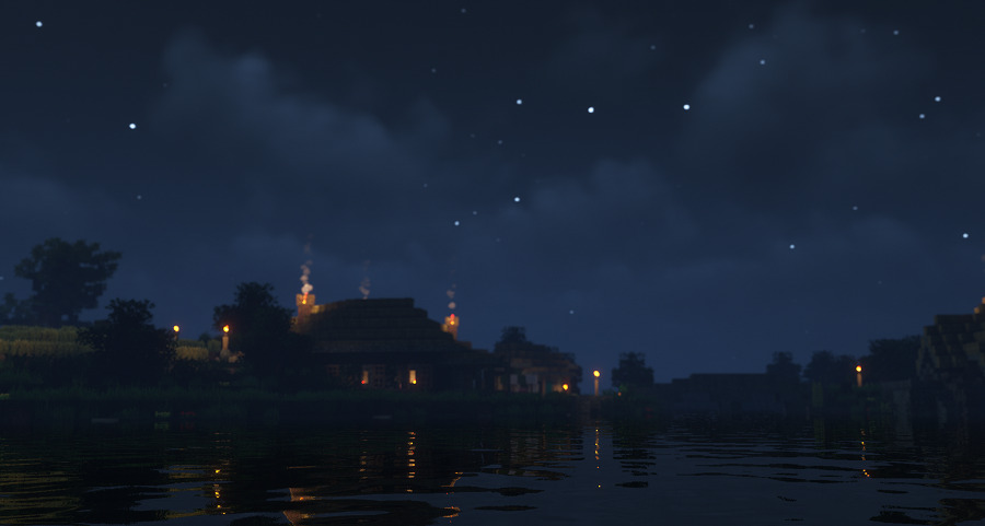 水辺に反射する民家の灯りの画像
